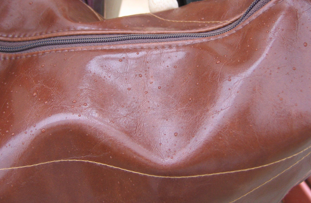 close up detail of brown hobo bag zipper