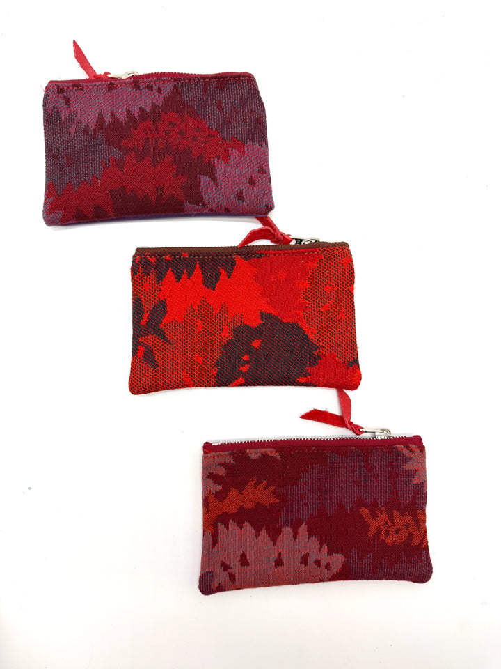 Three red and black camouflage pouches on a white background#color_red-ferns