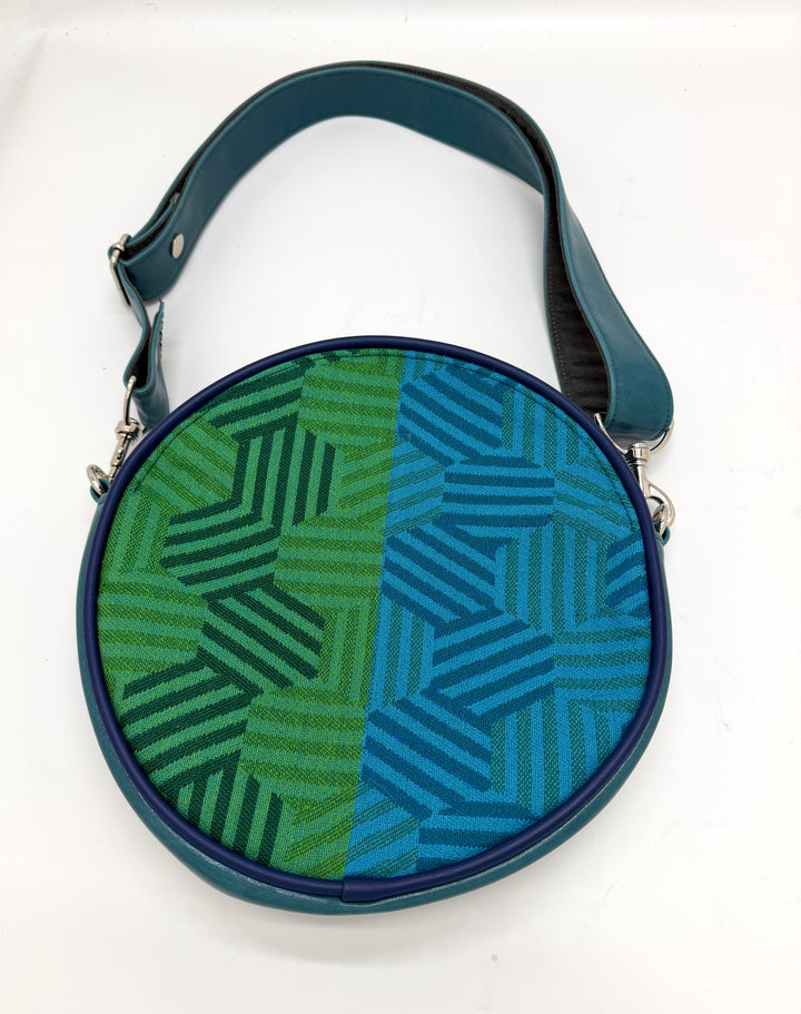 Round bag with green and blue geometric pattern on a white background#color_navy-teal-hexagon-airplane-fabric