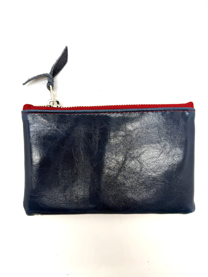 Black leather pouch with red zipper on a white background#color_parisian-harlequin