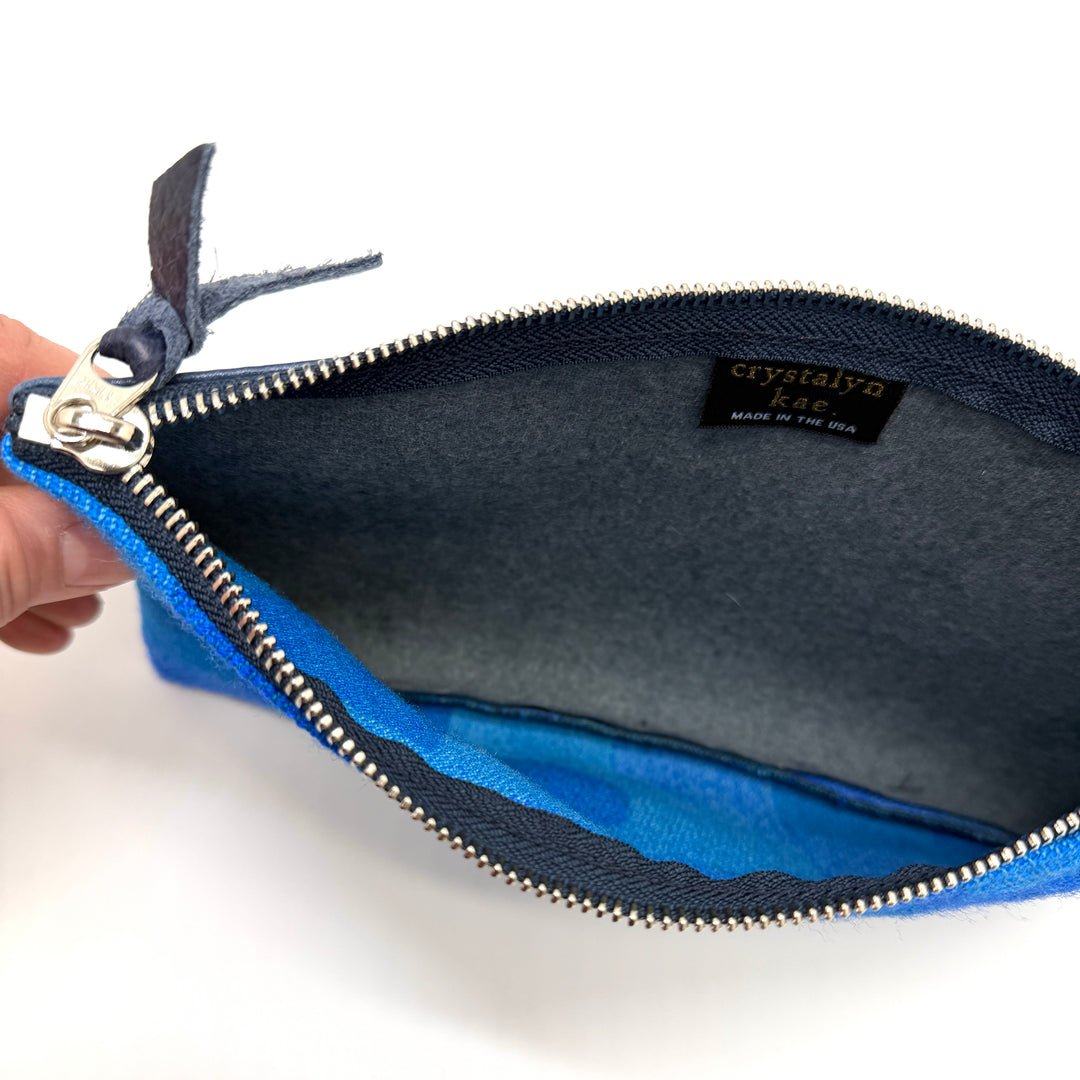 Blue pouch with a visible brand label on a white background#color_sky-arches-blue