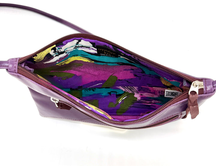 Purple handbag with a colorful interior on a white background#color_plum