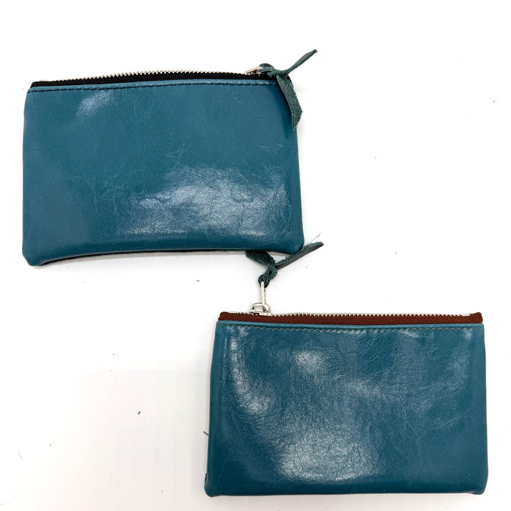 Two blue leather pouches with zippers on a white background#color_teal-ferns