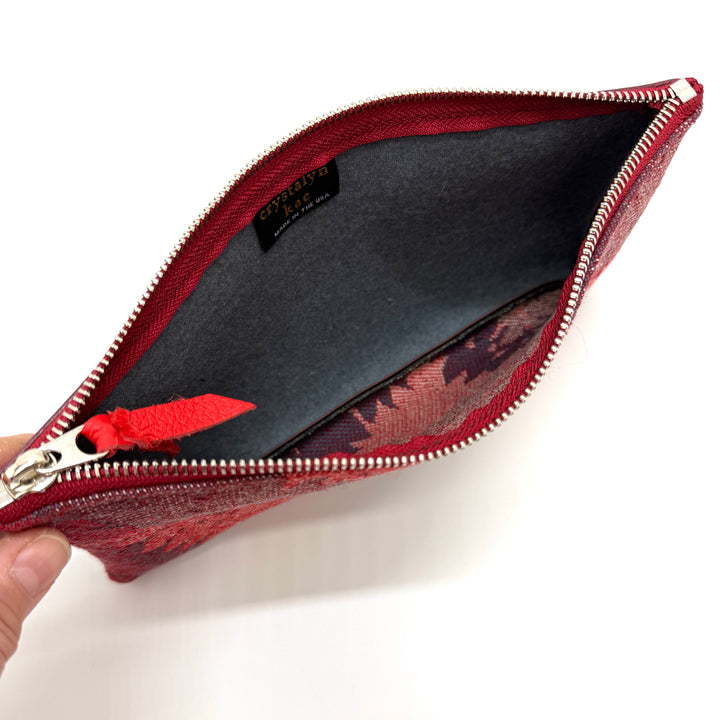 Red zippered pouch with floral pattern on a white background#color_red-ferns