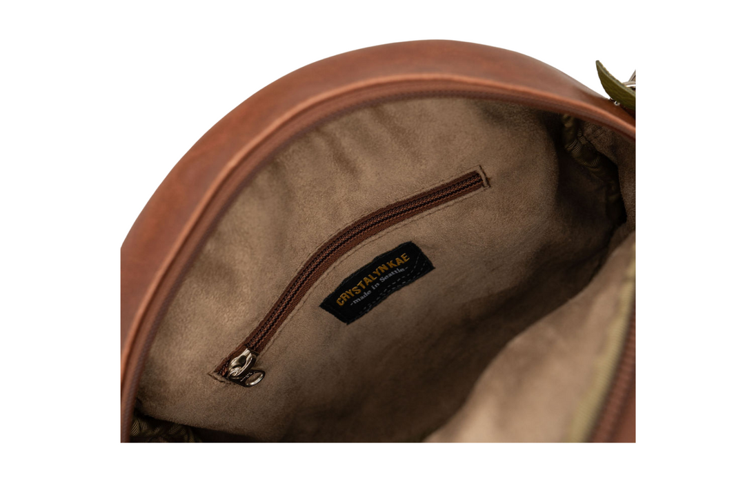 Close-up of a brown leather bag with a visible brand label on a white background#color_aerolinas-argentinas-green