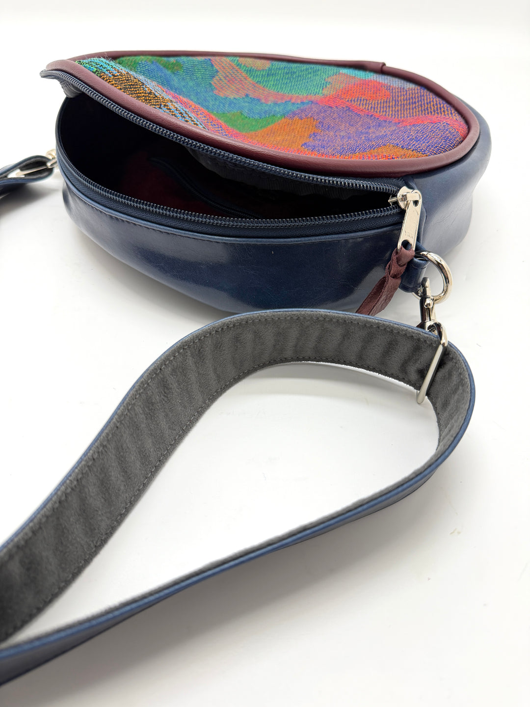 Navy blue handbag with a colorful top section on a white background#color_navy-clouds-airplane-fabric