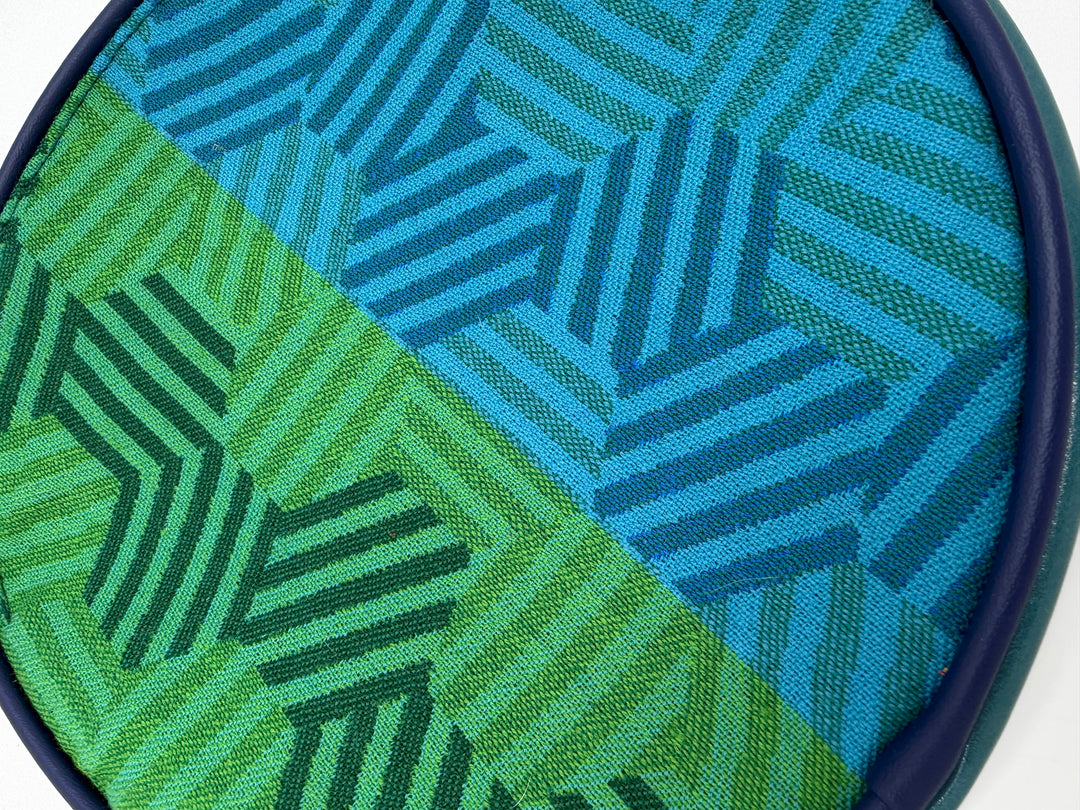 Close-up of a fabric with green and blue geometric pattern#color_navy-teal-hexagon-airplane-fabric