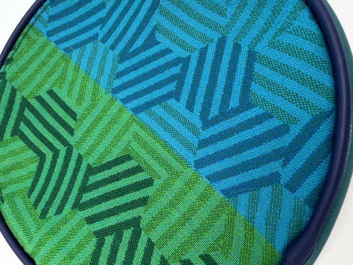 Close-up of a fabric with green and blue geometric pattern#color_navy-teal-hexagon-airplane-fabric