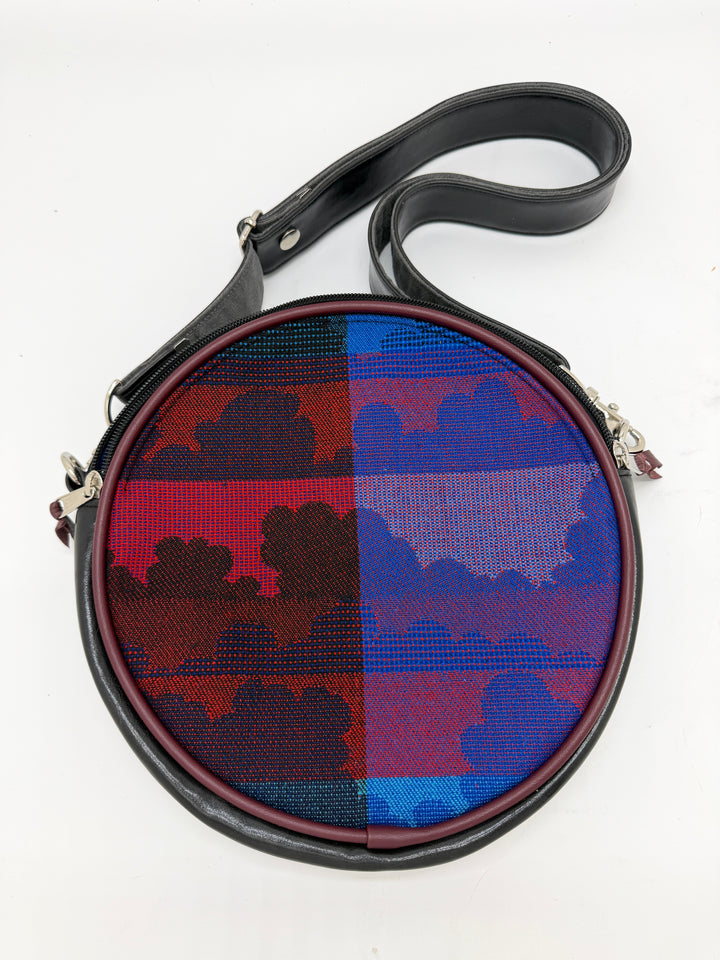 Round bag with a black handle featuring a red and blue checkered pattern on a white background#color_black-purple-clouds-airplane-fabric