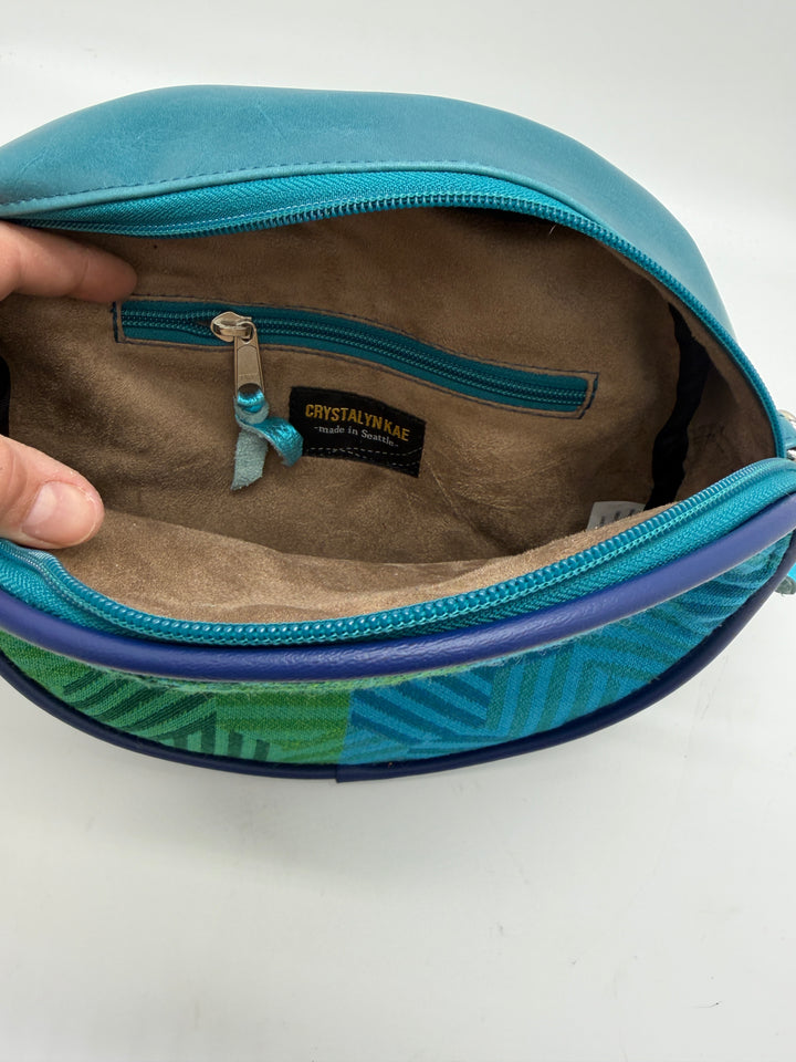 Blue pouch with a visible brand label on a white background#color_navy-teal-hexagon-airplane-fabric