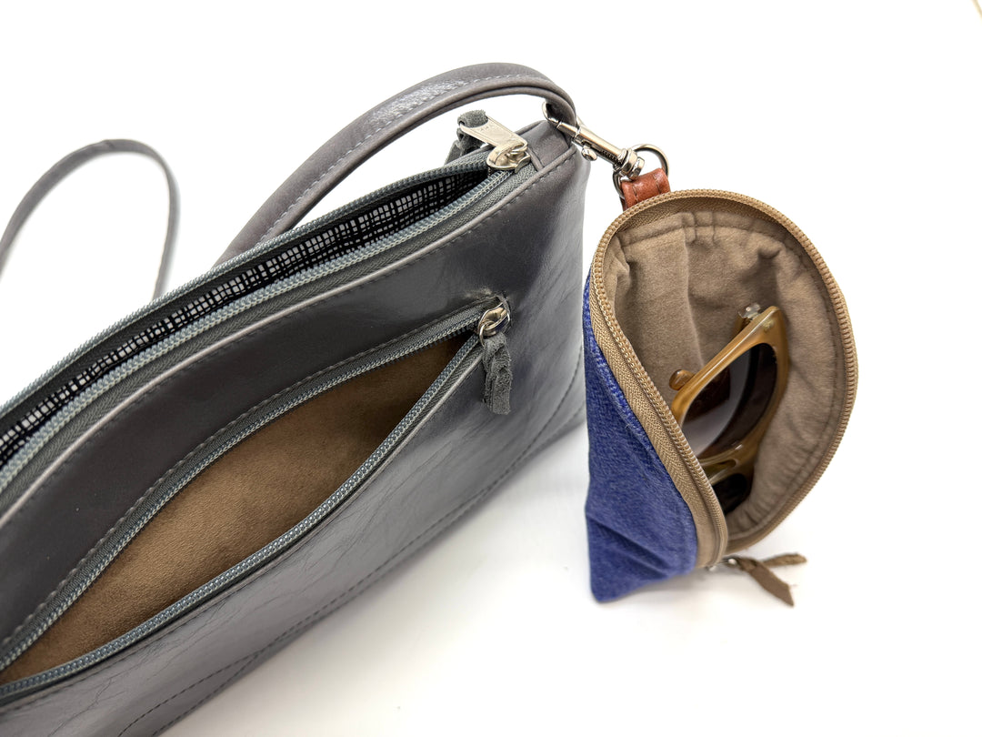 Gray handbag with a blue pouch inside on a white background