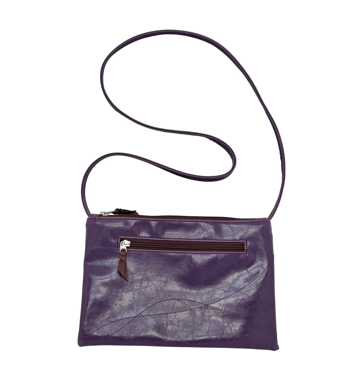 Purple leather crossbody bag with a strap on a light gray background#color_plum