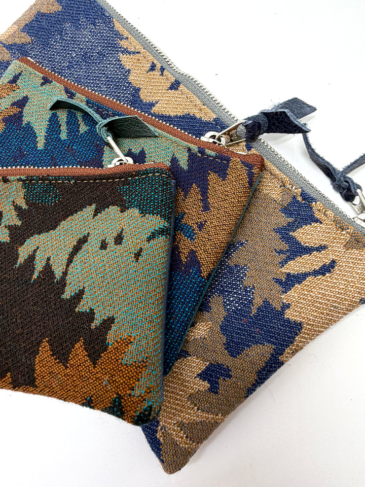 Two patterned pouches with zippers on a white background#color_blue-ferns