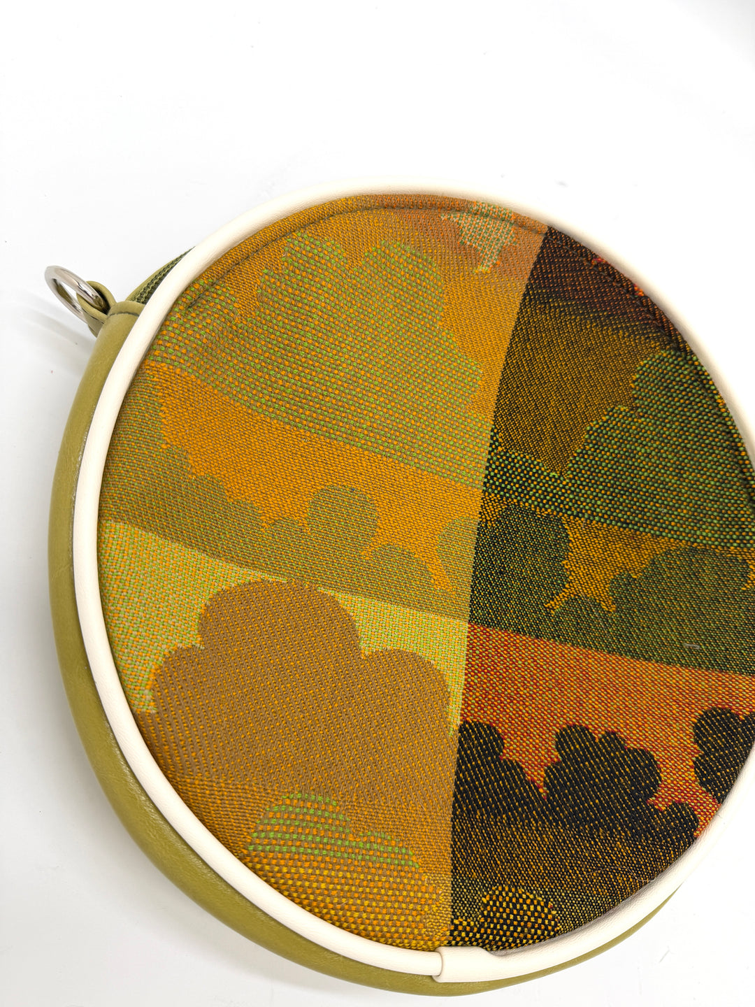 Round fabric sample with camouflage pattern in a metal hoop on a white background#color_citrine-clouds-airplane-fabric