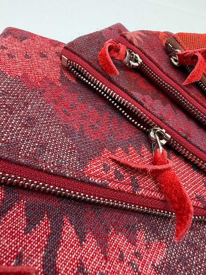 Red patterned bag with a zipper on a light gray background#color_red-ferns