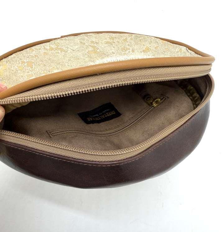 Round pouch with zipper, showing interior and brand label on a white background#color_gold-foil-ponyhair-leather