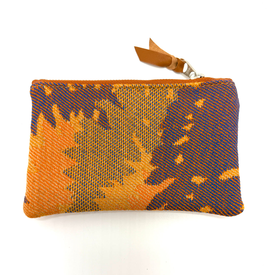 Rectangular pouch with orange and blue pattern on a white background#color_orange-ferns