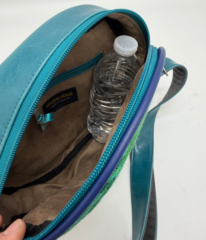 Blue bag with a water bottle inside on a white background#color_navy-teal-hexagon-airplane-fabric