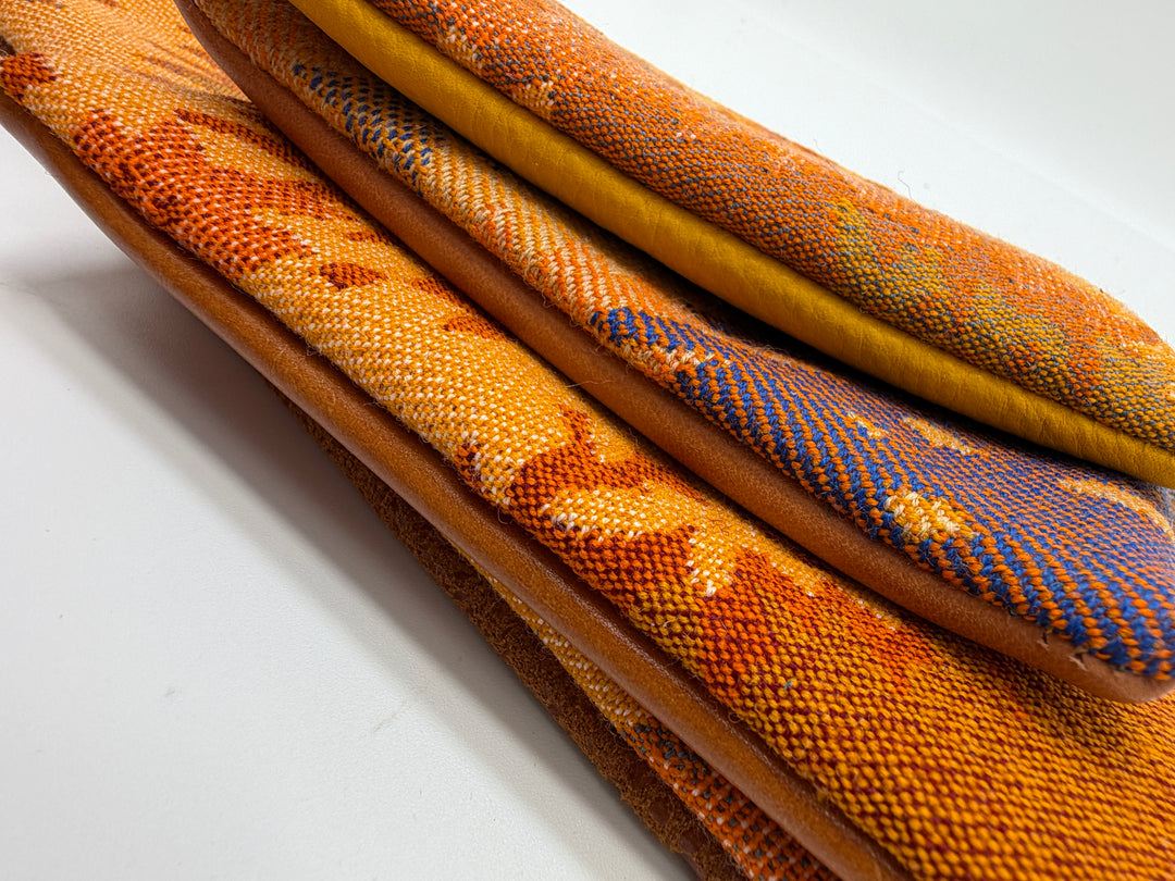Close-up of textured fabric samples in various colors on a white background#color_orange-ferns