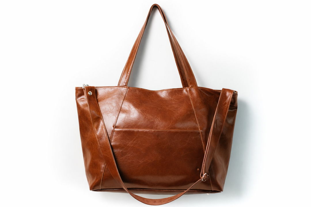 Brown leather tote bag on a white background#color_ale-brown