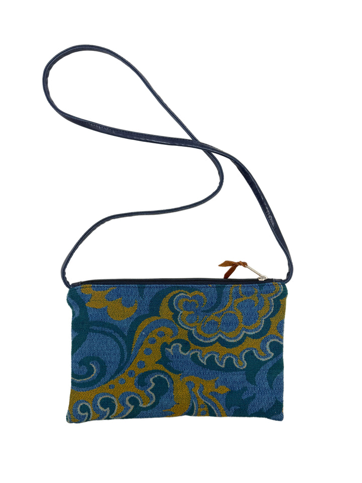 Blue and gold patterned pouch with a strap on a white background#color_western-airlines-paisley-blue-gold