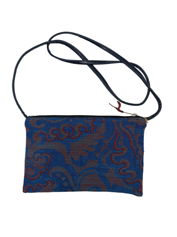 Blue and brown patterned vintage airplane fabric crossbody bag  with a navy blue strap on a white background#color_western-airlines-paisley-red
