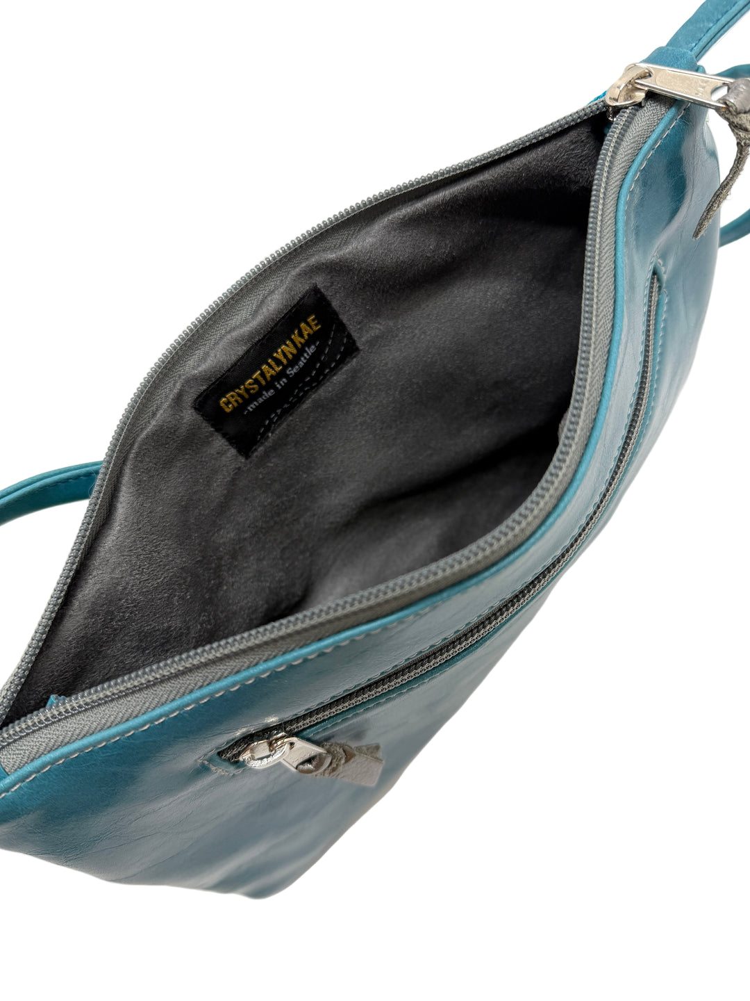 Blue handbag with a visible brand label on a white background#color_sky-arches-teal-green