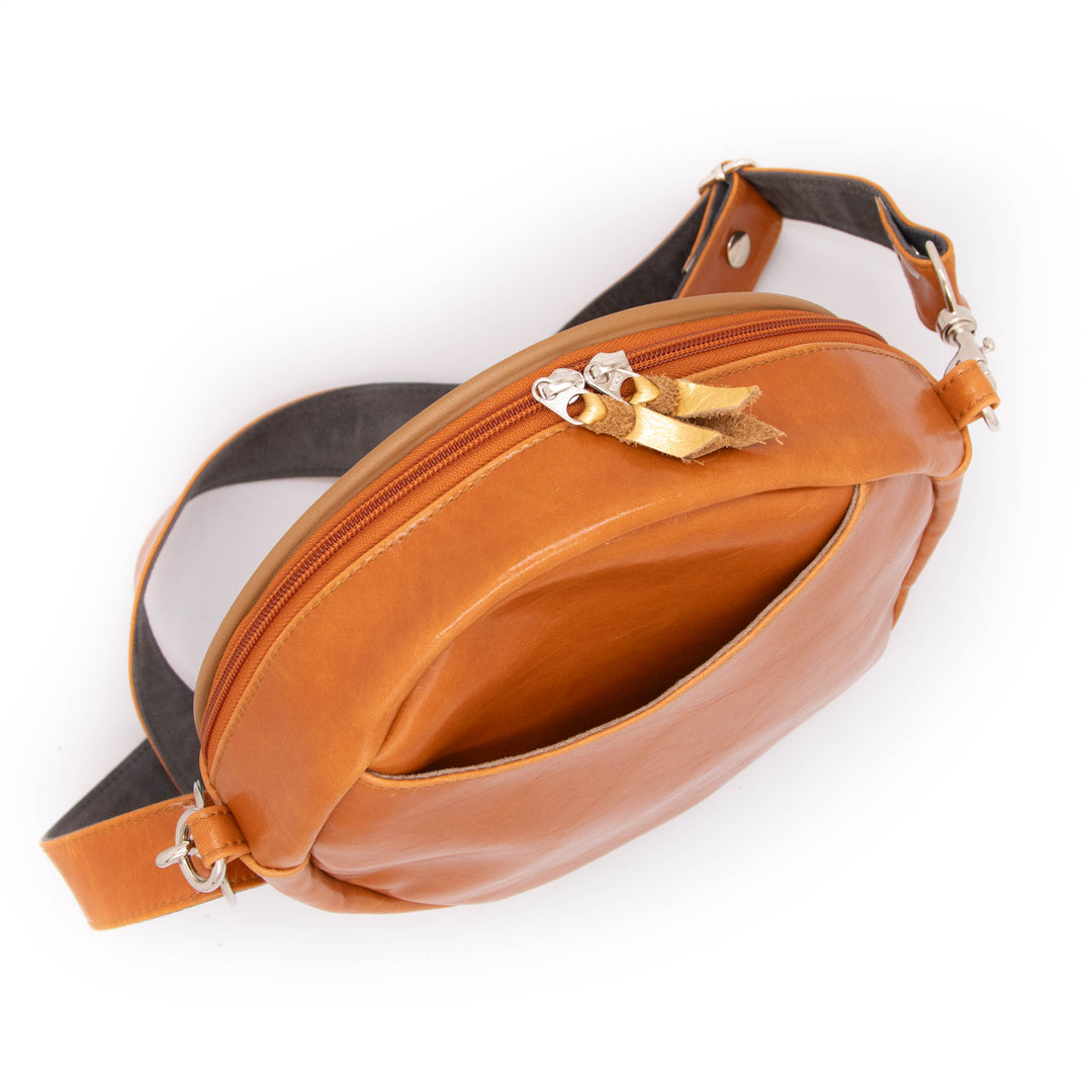 Brown leather bag with gold accents on a white background#color_egypt-air-orange-gold