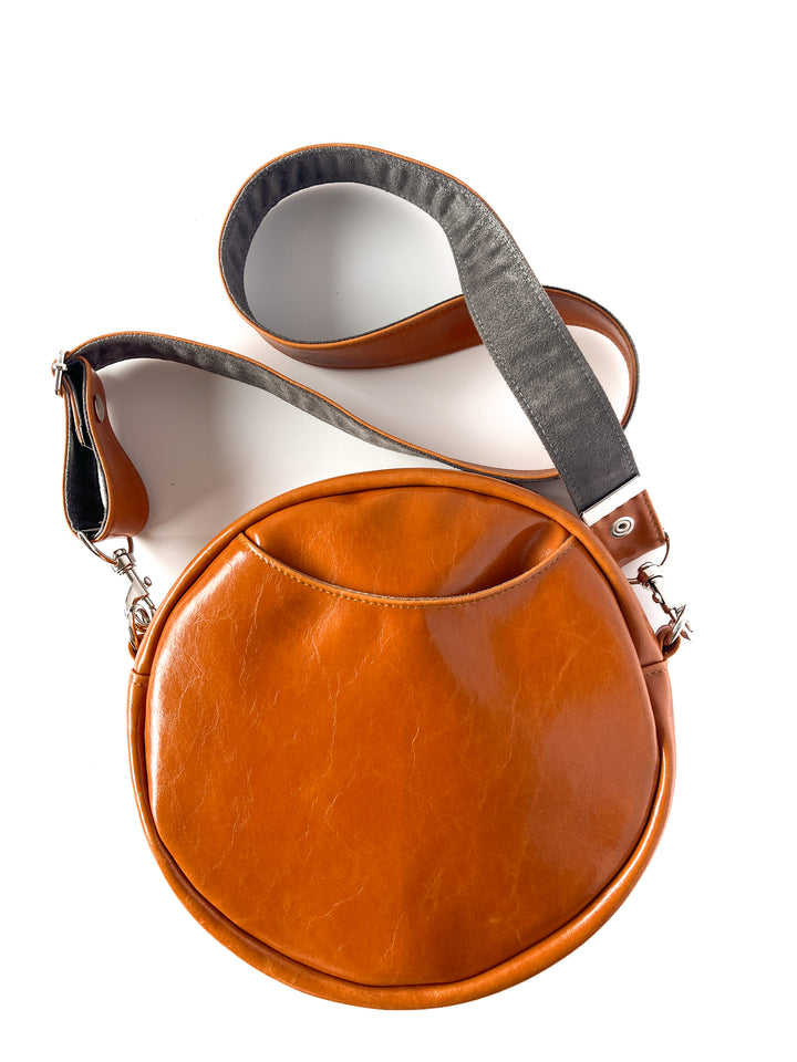 Brown leather crossbody bag with a gray strap on a white background#color_white-french-floral-brocade
