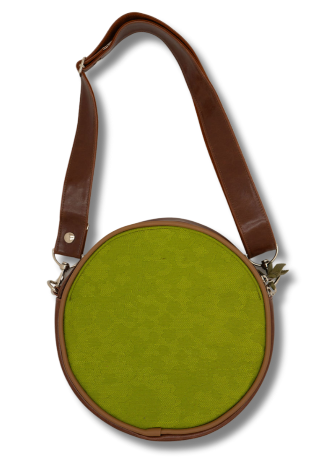 Round green bag with brown leather strap on a white background#color_aerolinas-argentinas-green