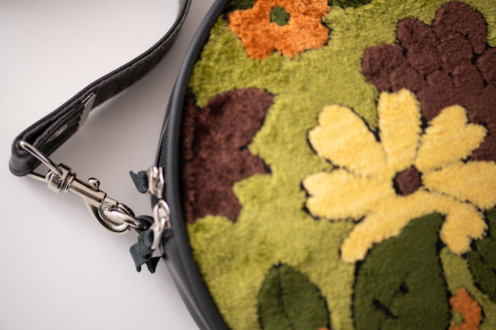 Floral-patterned pouch with a black strap on a white background#color_groovy-green-floral-chenille