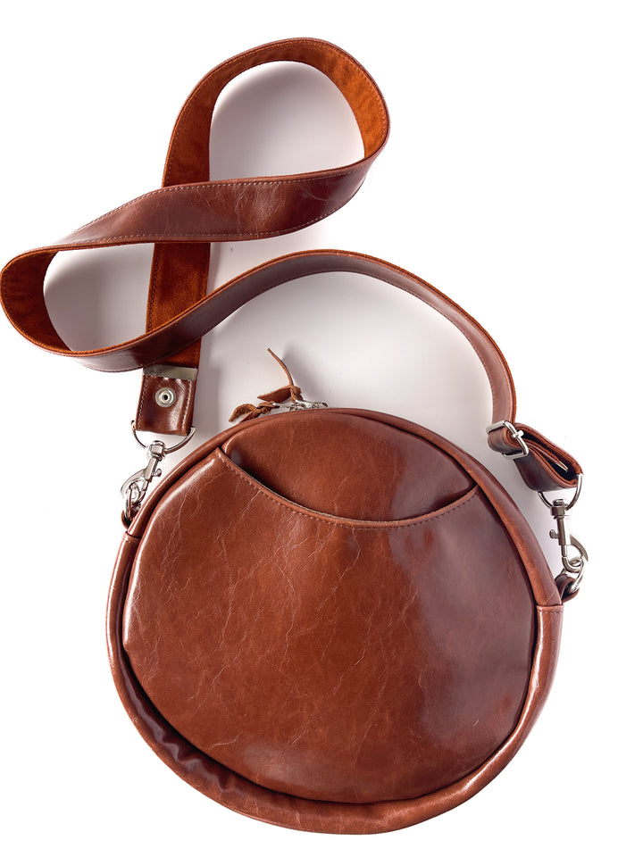 Brown leather handbag with a strap on a white background#color_ornate-mossy-green-chenille