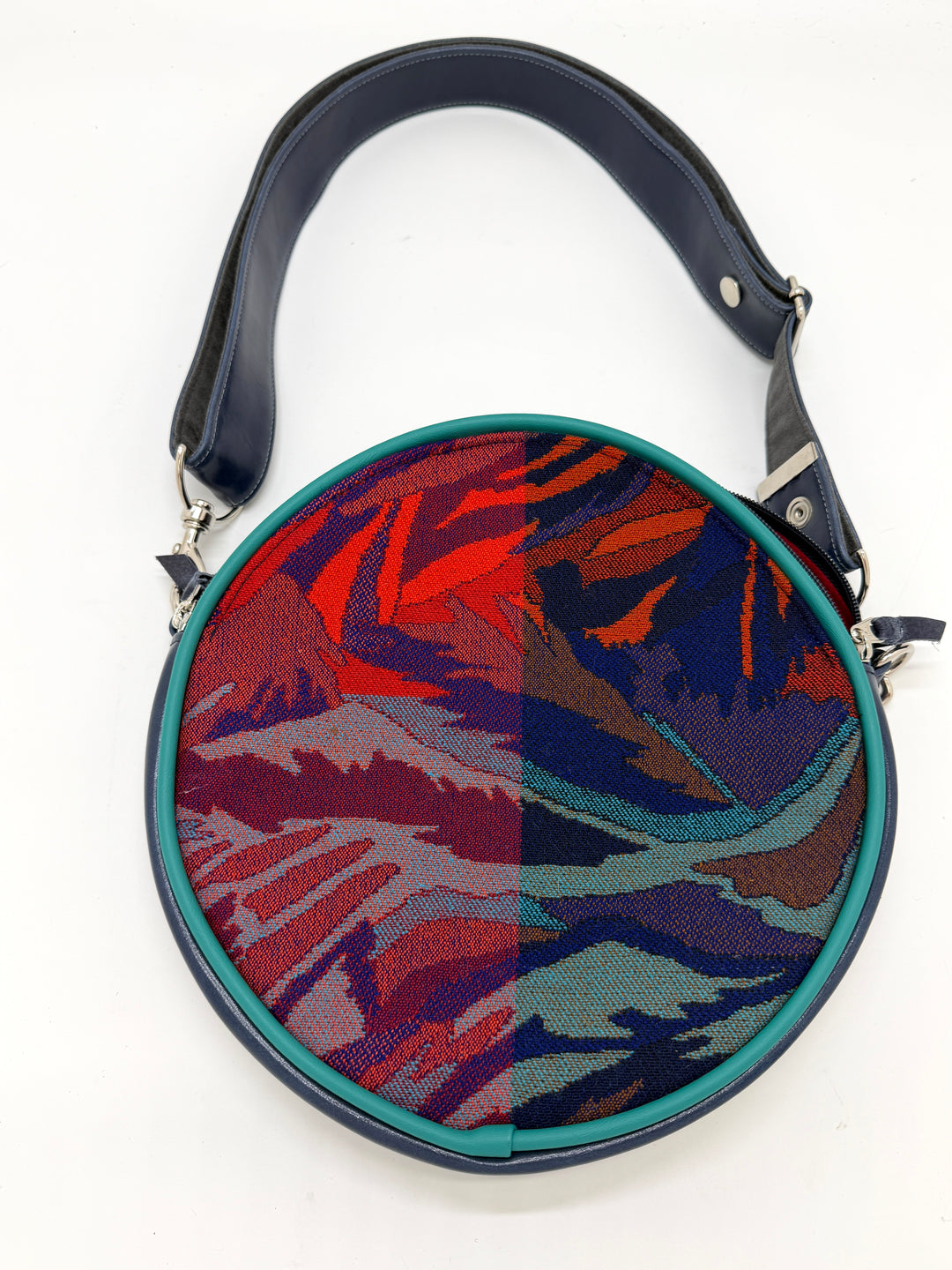 Round handbag with colorful abstract pattern on a white background#color_palm-fronds-cool