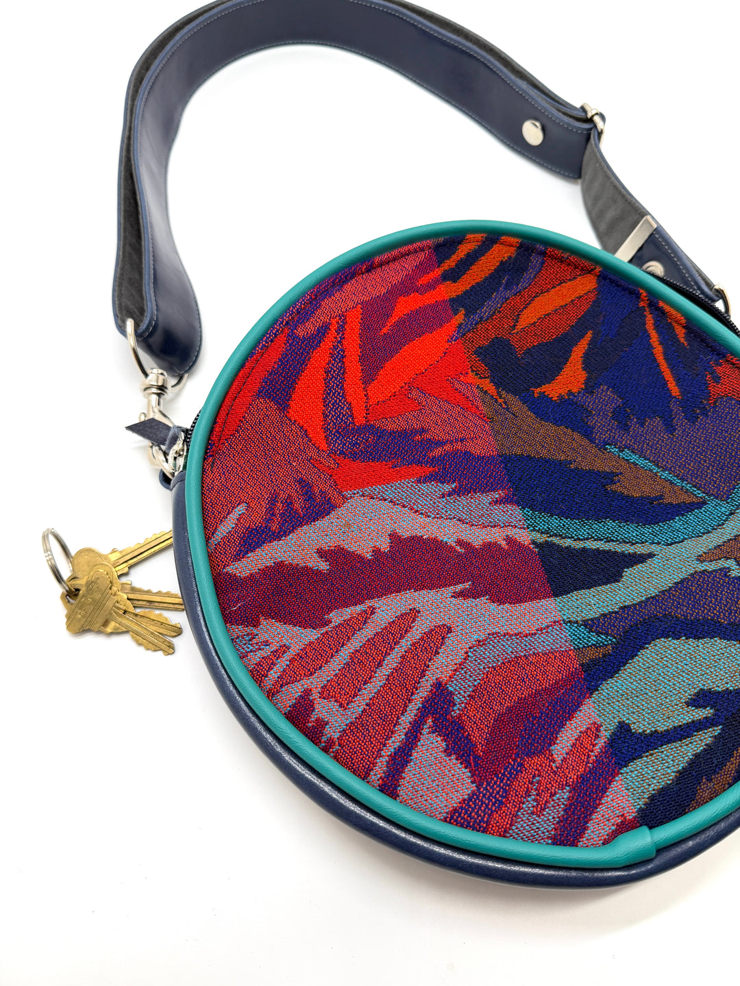 Colorful handbag with a geometric pattern on a white backgroundRound handbag with colorful abstract pattern on a white background#color_palm-fronds-cool