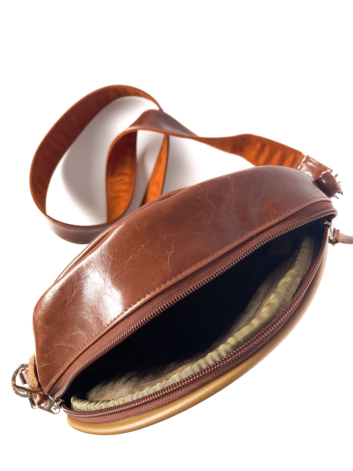 Brown leather bag with a strap on a white background#color_bargello-needlepoint