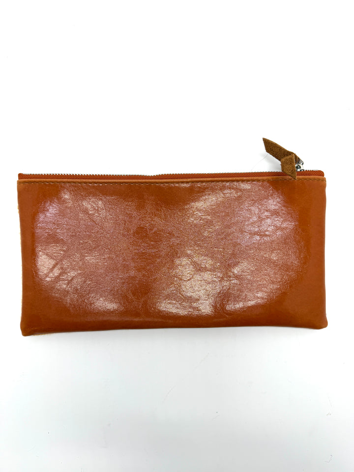 Brown leather pouch with a zipper on a white background#color_clouds-warm
