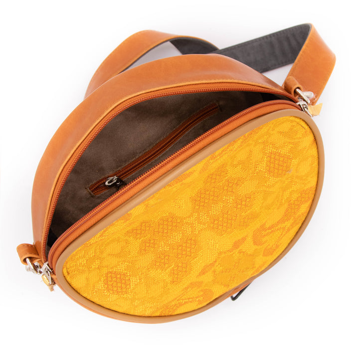 Brown leather bag with yellow interior on a white background#color_egypt-air-orange-gold