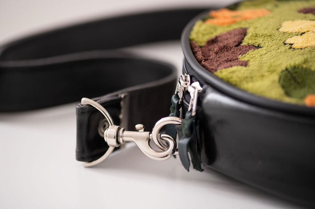 close up detail of silver hardware on circle bag#color_groovy-green-floral-chenille