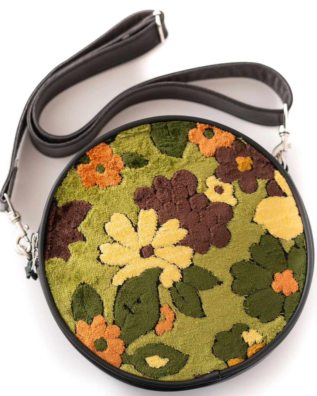 Round floral-patterned bag with a black strap on a white background#color_groovy-green-floral-chenille