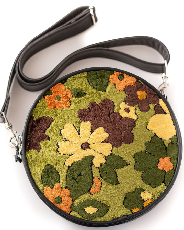 Round floral-patterned bag with a black strap on a white background#color_groovy-green-floral-chenille