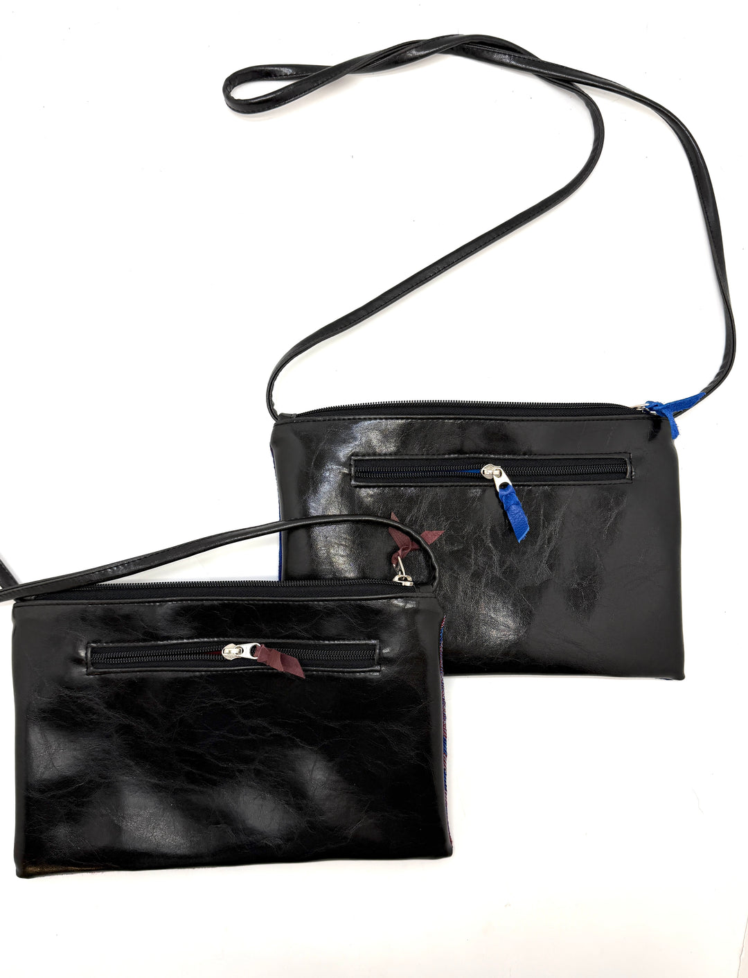 Two black leather handbags with zippers on a white background@color_hexagon-cool