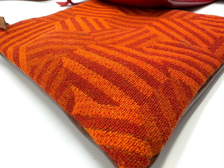  hexagon-patterned crossbody bags in red, orange, and blue on a white background#color_hexagon-warm