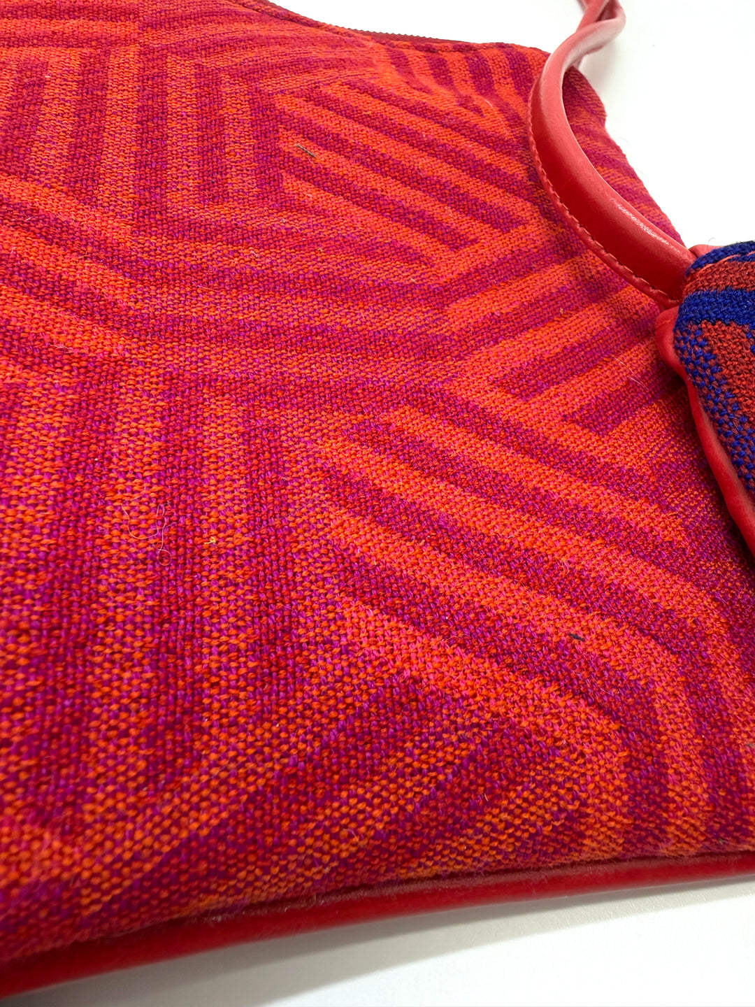 Close-up of a red and orange textured fabric with a white background#color_hexagon-warm