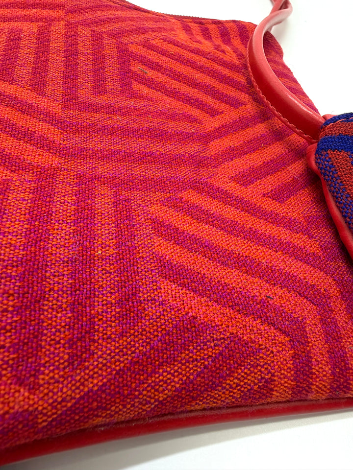 Close-up of a red and orange textured fabric with a white background#color_hexagon-warm