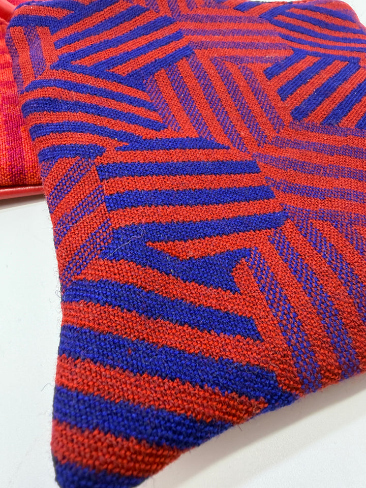 Close-up of a blue and orange patterned fabric purse#color_hexagon-warm