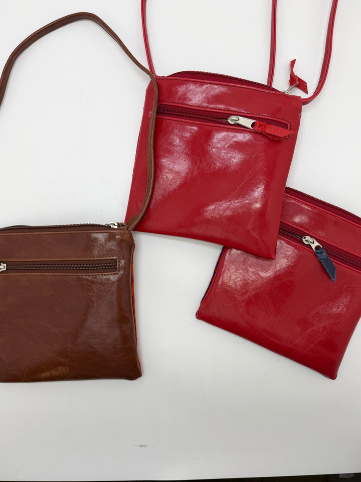 Two red handbags and one brown handbag on a white background#color_hexagon-warm