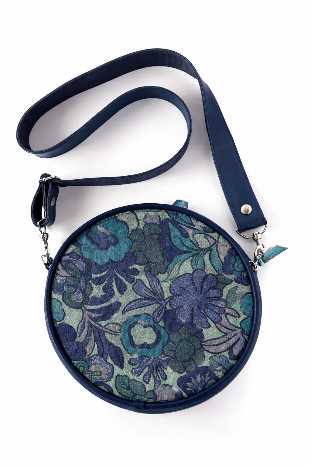 Round floral-patterned bag with a blue strap on a white background#color_navy-bloom