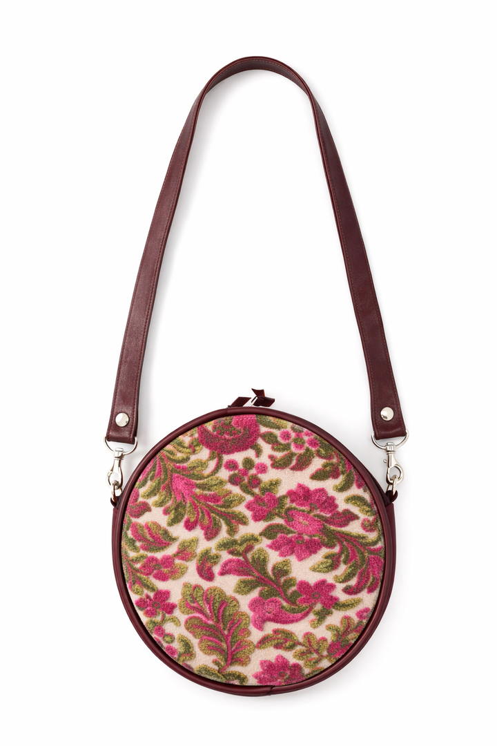 Round floral-patterned bag with a brown strap on a white background#color_fuchsia-moss-velvet-floral