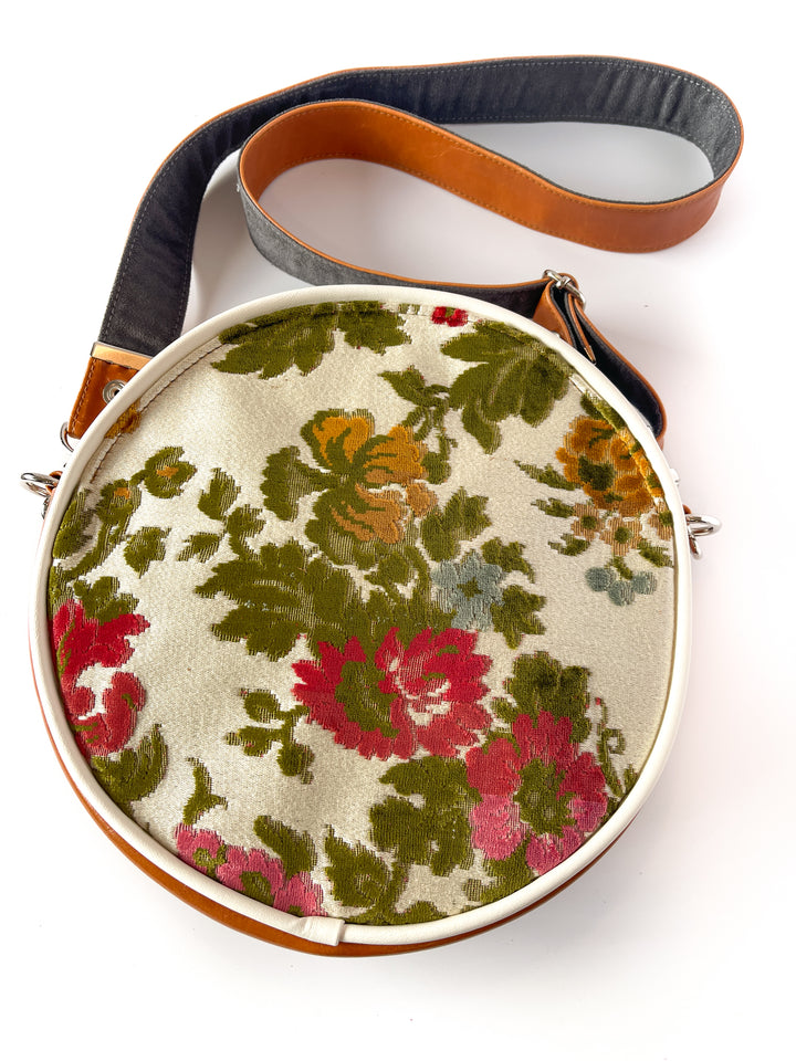 Round floral-patterned bag with a strap on a white background#color_white-french-floral-brocade
