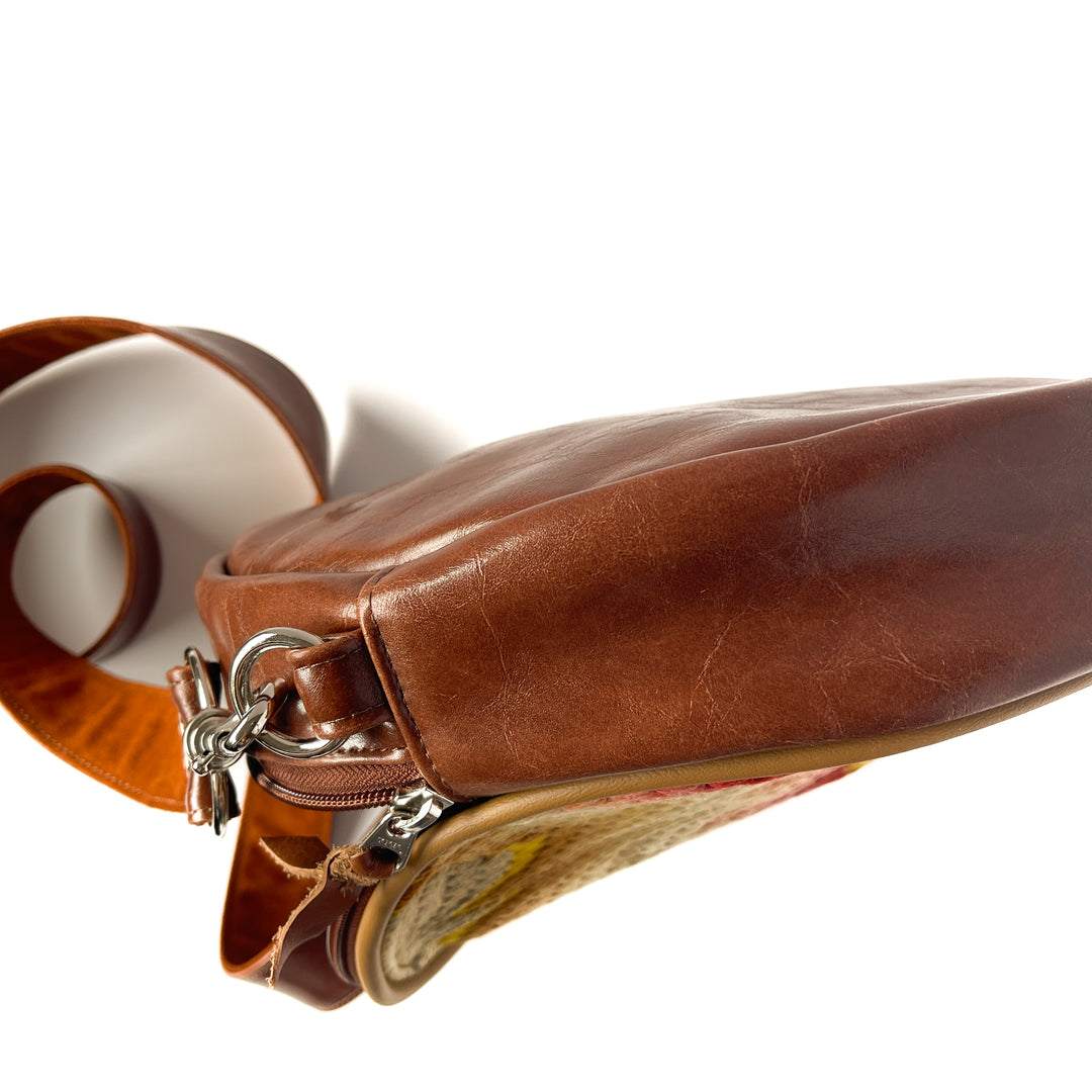 Brown leather handbag with a strap on a white background#color_bargello-needlepoint